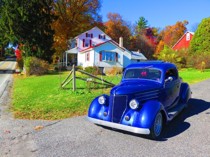 A Blue 1936 Ford V8 pulls out of a country road on a fall day<br>
[photo credit: Steve Hogan]